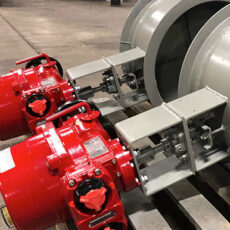 Close-up of a red painted actuator that is used on industrial dampers.