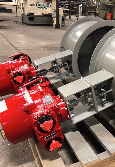 Close-up of a red painted actuator that is used on industrial dampers.