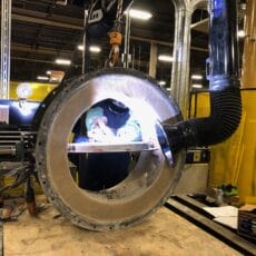 A Kelair shop worker welds an industrial damper.